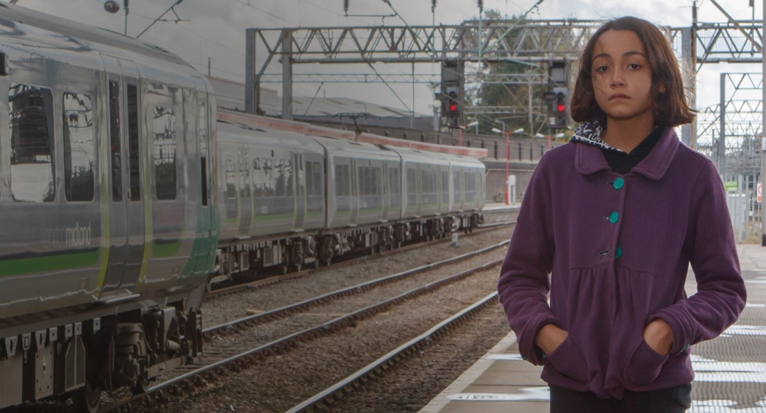 Girl alone at train station)