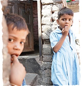 Street children in India by a wall