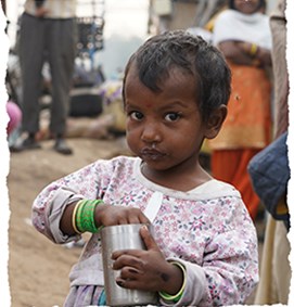Street child in India holding a can