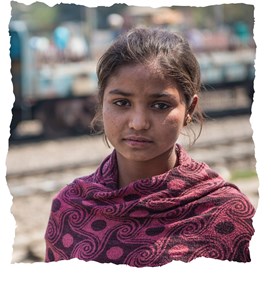Isha, a girl in India, at a railway station