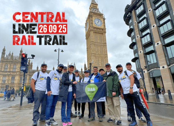 A group of ramblers stood in front of Big Ben, participating in Railway Children's Rail Trail event. There is a logo on the image which reads 'Central Line Rail Trail 26.09.25'