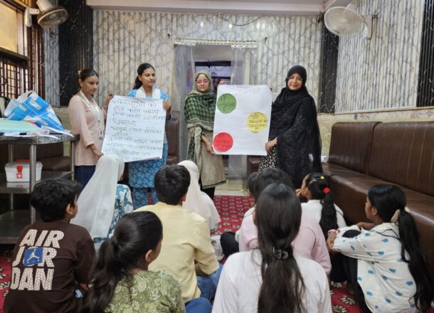 Facilitators leading a group session with young people as part of a child protection and community engagement workshop.