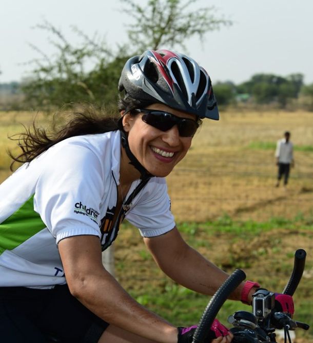 Female cyclist smiling at camera.