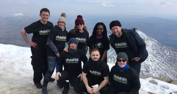 Group of event participants at the top of a snowy mountain.