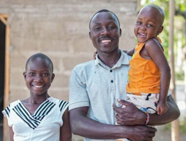 Family in Tanzania smiling at camera