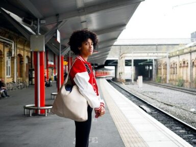 Young teen girl waiting at a train platform.
