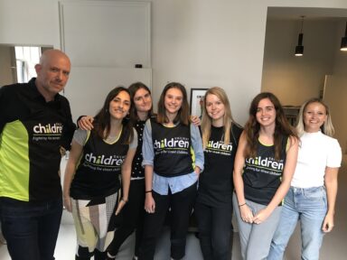 A group of employees from Not Actual Size wearing Railway Children running vests