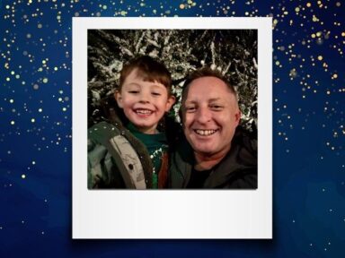 Man smiling with his young son, in a polaroid picture frame