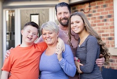 Family stood outside their house.