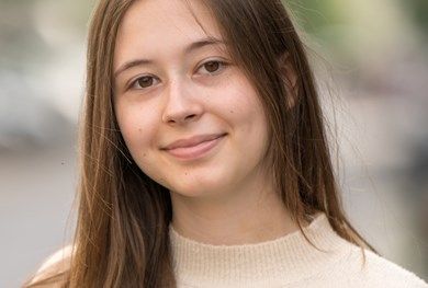 Brunette girl smiling at camera.
