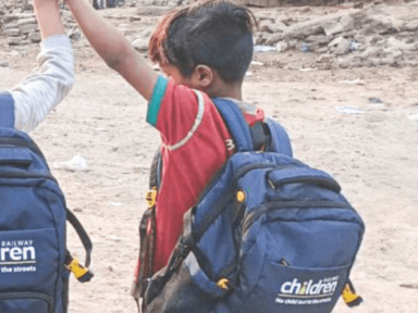 back of a young boy in India with school backpack