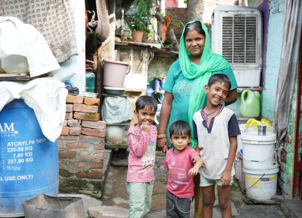 A woman stood outside with her three young children.