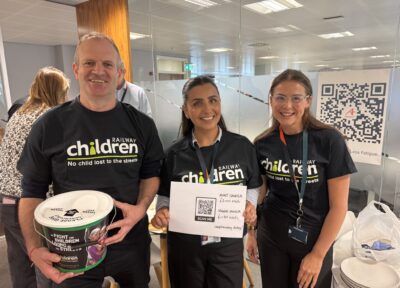 Avanti West Coast employees wearing Railway Children T-shirt and holding a fundraising bucket.