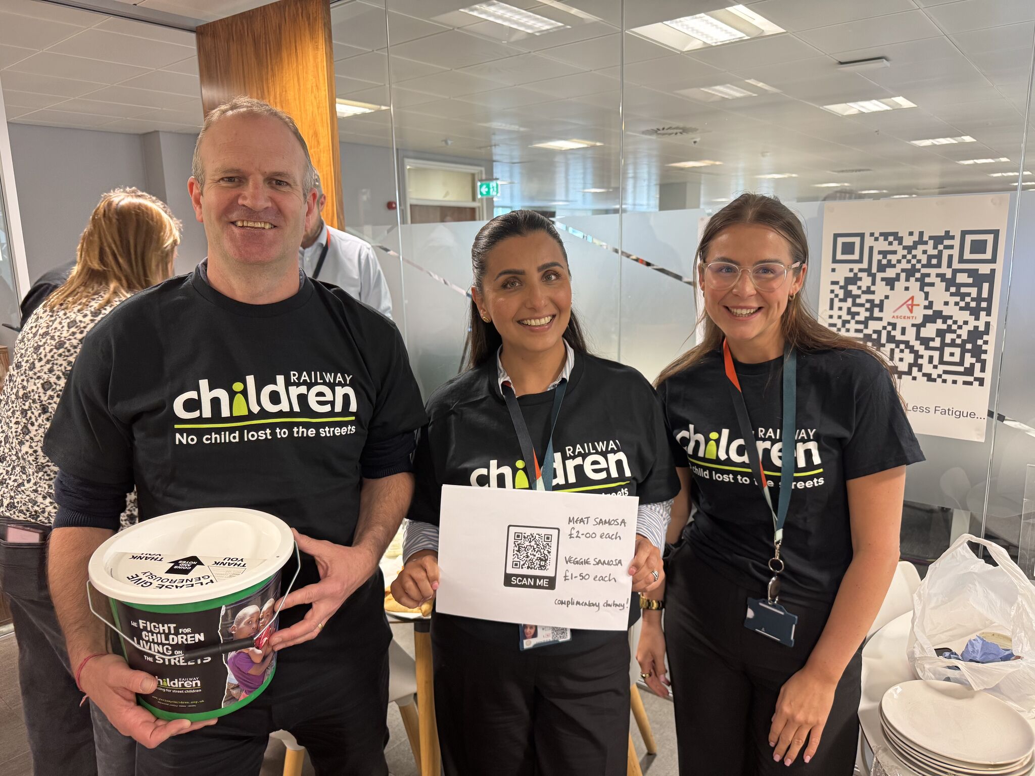 Avanti West Coast employees wearing Railway Children T-shirt and holding a fundraising bucket.