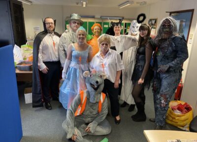 Group of people dressed up up in halloween outfits.