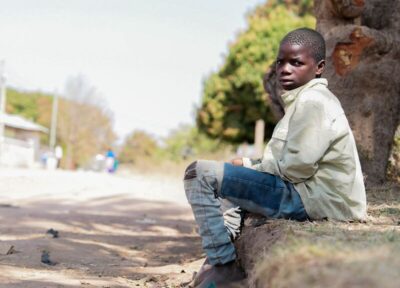 African child sitting on street