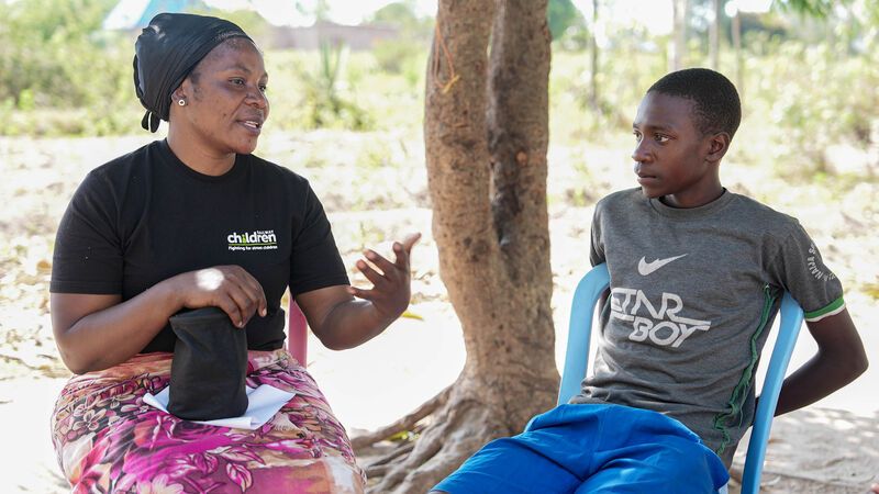 Family worker speaking to young person in Tanzania