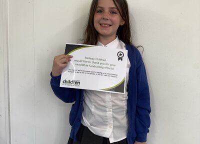 Young school girl holding a certificate.
