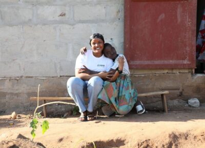Youth worker and young person hugging and smiling