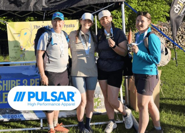 A team of Pulsar colleagues holding medals at Railway Children's Yorkshire Three Peaks event. Pulsar logo added next to group.