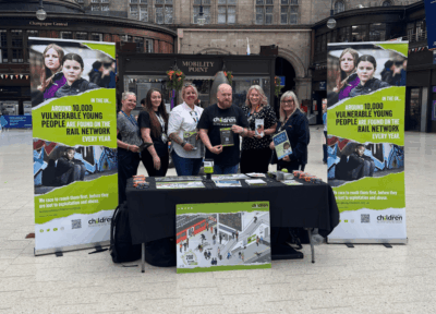 Railway children stand at railway station safeguarding