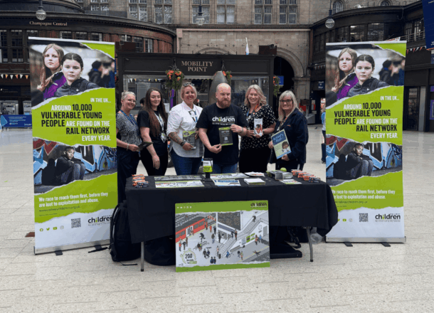 Railway children stand at railway station safeguarding