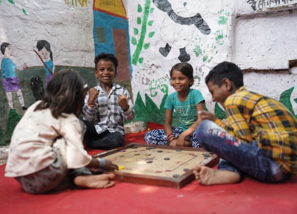 Young children in a classroom in India playing a game.