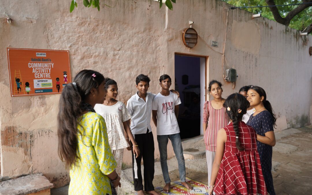 A group of children stood talking outside a Railway Children India Child Activity Centre.