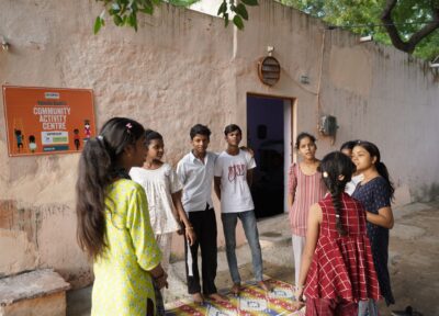 A group of children stood talking outside a Railway Children India Child Activity Centre.