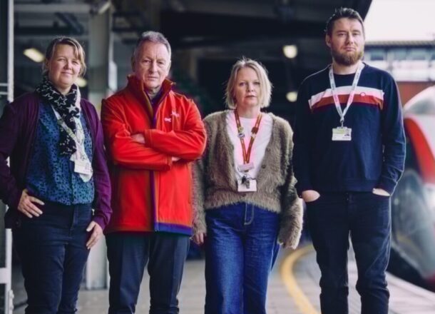 Rail staff and Railway Children staff standing on train platform