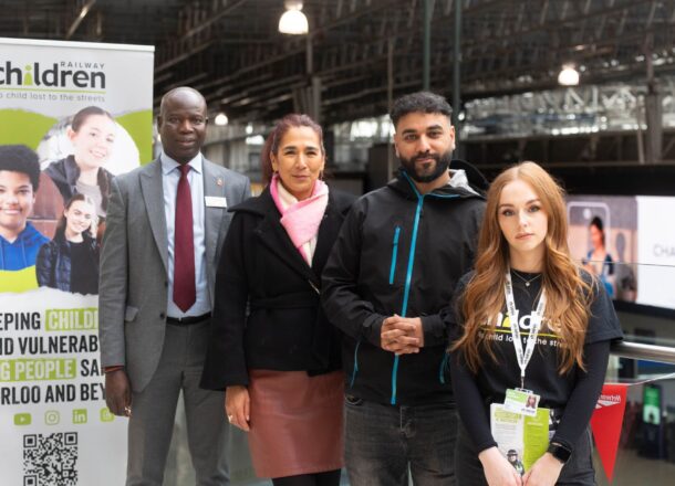 A group of people stood at Waterloo Station by a Railway Children banner which reads keeping vulnerable children safe across Waterloo and beyond.