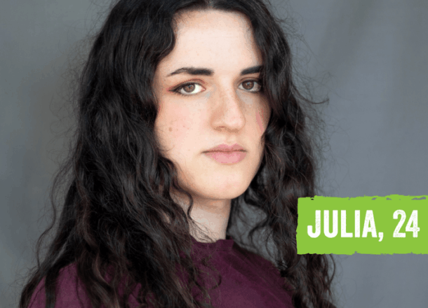 A young woman in front of a grey background with dark hair and wearing a purple jumper. Text on image in a green box reads: Julia, 24.