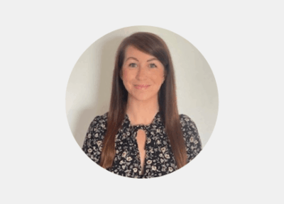 Head-and-shoulders portrait of a Railway Children staff member wearing patterned clothing, photographed against a plain light background.