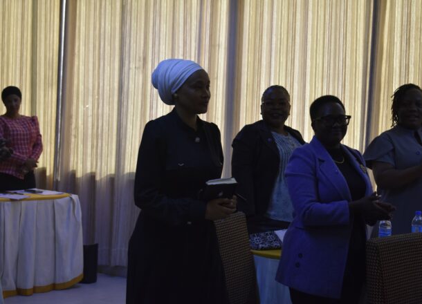 A group of women dressed smartly standing inside