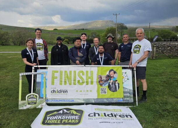 A group of Yorkshire Three Peaks participants at the finish line after completing the challenge.