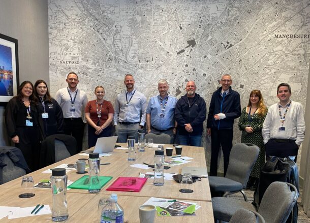 A group of people who are part of one of Railway Children's Safeguarding Action Group's, in a meeting room.