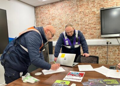 Two people from the rail industry taking part in one of Railway Children's training programmes in an office space.