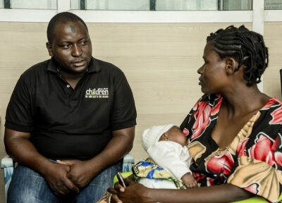 Parent and baby receiving support through a charity-led community programme that promotes family wellbeing and child development.