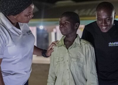 Child welfare workers supporting a young person during an evening outreach program