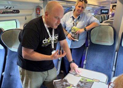 Staff from Railway Children and Avanti West Coast on a train talking to passengers during Days of Action 2026.