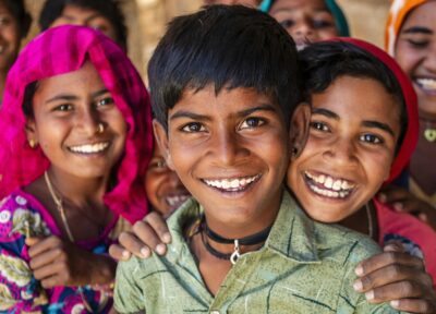 Children in a local community supported by charitable programmes focused on education, protection and long-term development.