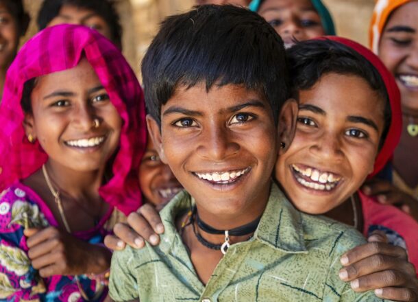 Children in a local community supported by charitable programmes focused on education, protection and long-term development.