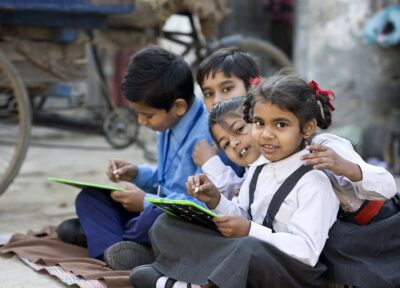 Children engaged in educational activities through a charity programme supporting learning opportunities and brighter futures.