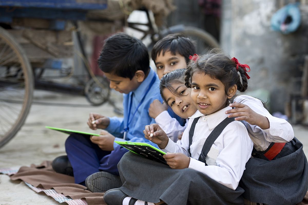 Children engaged in educational activities through a charity programme supporting learning opportunities and brighter futures.